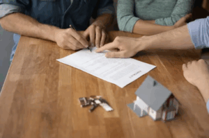 people on a table signing documents