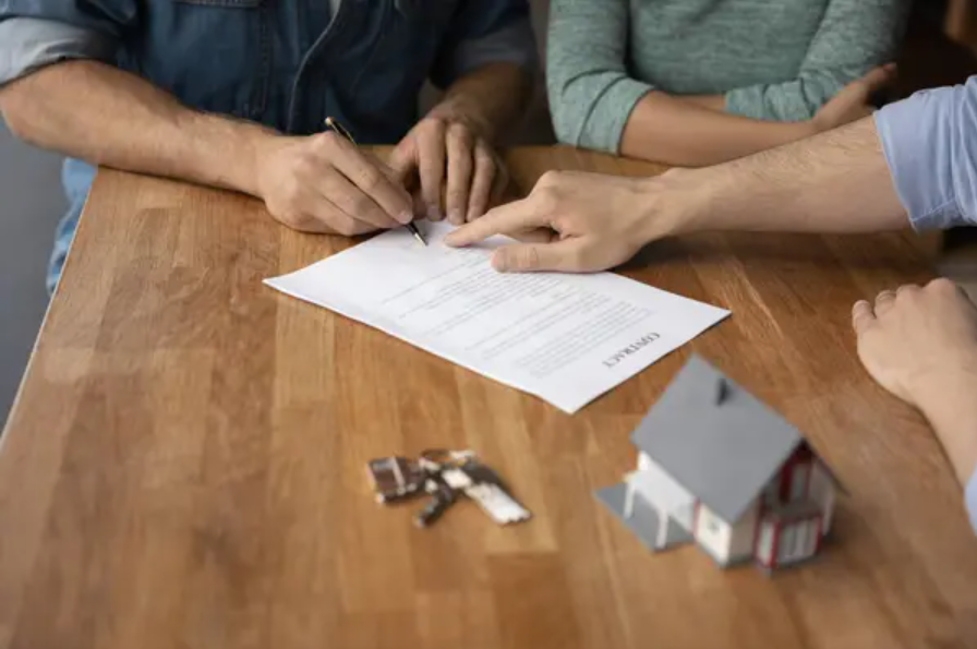 people on a table signing documents